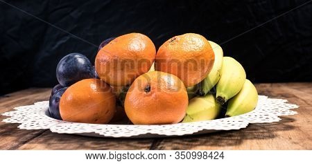 Fresh Fruit (orange, Plum, Banana, Kiwi) In The Basket On A Vintage Wooden Table
