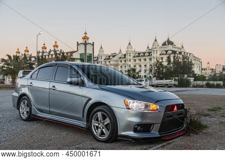 Side, Turkey - February 02 2022:  Silver Mitsubishi Lancer    Is Parked  On The Street On A Warm  Au