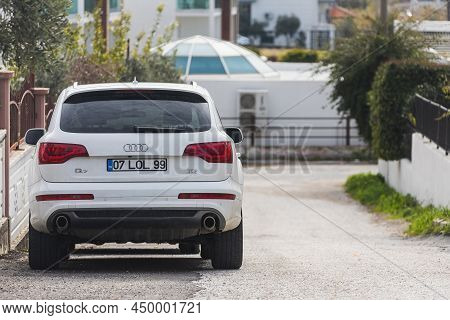 Side, Turkey - February 06 2022: White  Audi Q7   Is Parked  On The Street On A Warm  Day Against Th