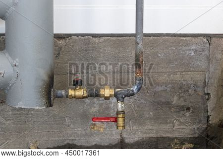 Erting A Pipe Into A Heating System. Installation Of A Heating Unit In A Production Room. Metal Pipe