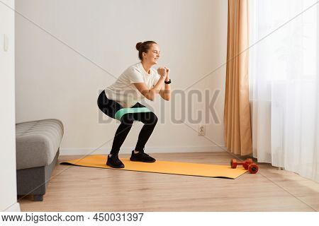 Image Of Sporty Woman Wearing White T Shirt And Black Leggins Doing Sport Exercises At Home, Doing S