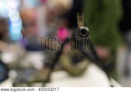 The Muzzle With The Sight Of An Army Assault Rifle Is Pointed At The Camera. Close-up Of The Weapons