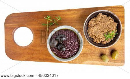 Tapenade - Paste Made From Olives. Bowls With Spreadable Black And Green Olive Cream On Cutting Boar