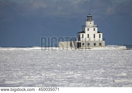 Lake Michigan Lighthouse And The Frozen Mouth Of The Manitowoc River