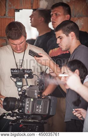 Behind The Scenes. Film Crew Team Shooting Movie Scene On Outdoor Location. Group Filmmaking Set Pro