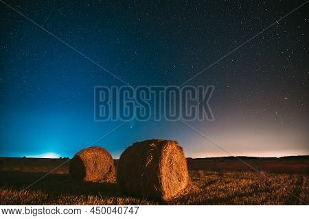 Comet Neowise C2020 F3 In Night Starry Sky Above Haystacks In Summer Agricultural Field. Night Stars