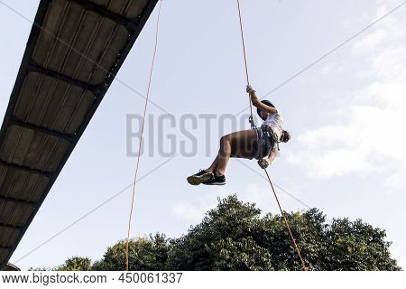 Woman Practicing Rappel On A Pedestrian Walkway. Salvador Bahia Brazil.