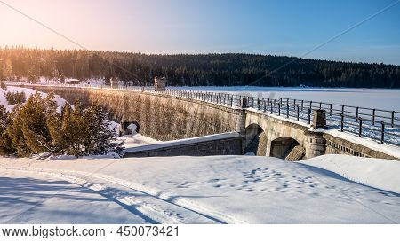 Cerna Nisa, Or Bedrichov, Dam In Sunny Winter Evening. Snowy Landscape Wing Long Sunset Time Shadows