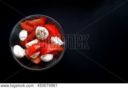 Caprese Salad On A Black Background. Top View