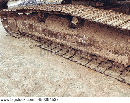 Caterpillar Of An Old Tractor. Rusty Caterpillar, Part Of Military Equipment. Museum Exhibit, Observ