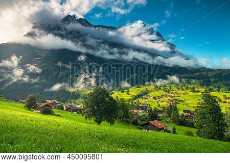 One Of The Most Beautiful And Visited Alpine Village In The Alps With Famous Eiger Mountain In Backg