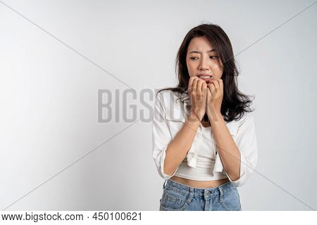 Sad Portrait Of Young Asian Woman Over Isolated Background
