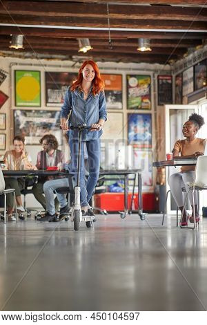 Young employees reaxing together at the office; Casual workspace concept