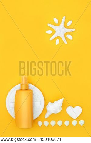 SPF sunscreen suntan protection for skincare with bottle, ex foliation scrub, soap, abstract starfish sun and decorative sea shells. Anti ageing skin care cancer health care concept. On yellow backgro