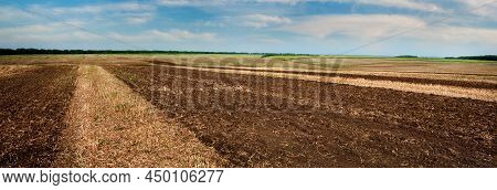 Plowed Land In The Foreground, Groves And Hills In The Background Of Rural Lands
