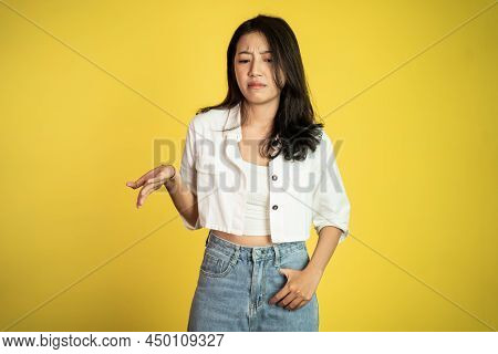 Sad Portrait Of Young Asian Woman Over Isolated Background