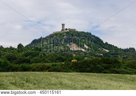 Rocca Of Radicofani Fortress On The Top Of A Green Tuscan Hill From. Italy