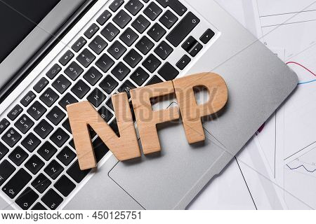 Wooden Letters Nfp, Laptop And Charts On Table, Flat Lay