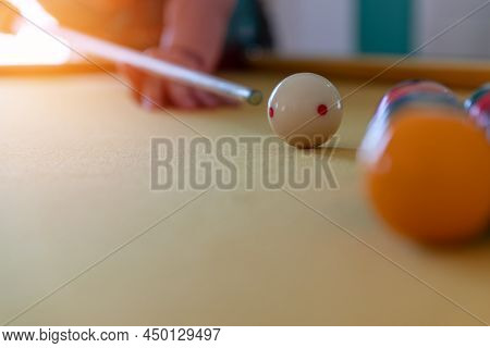 Man Cue Aiming On Billiard Ball At Table. Snooker Or Pool Billiard Equipment Of Colorful Balls With