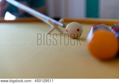 Man Cue Aiming On Billiard Ball At Table. Snooker Or Pool Billiard Equipment Of Colorful Balls With
