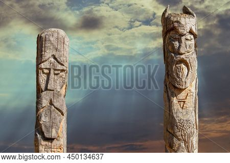 Northern Lands. A Pagan Temple In The Taiga With Two Wooden Idols. The Image Of Pagan Gods Is Carved