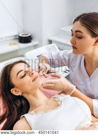 Closeup Image Of Dermatologists Hands Doing Electro-epilation. The Process Of Electrolysis On The Fa