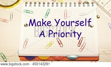 Make Yourself A Priority Text On A Notebook In A Cage With Scattered Paper Clips On A Notebook And A