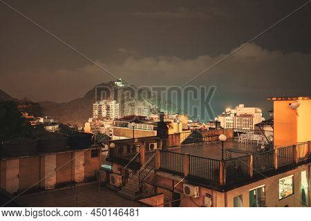 A Night, Long Exposure Shot Of A Residential Favela Area In Babilonia, In Leme District Of Rio De Ja