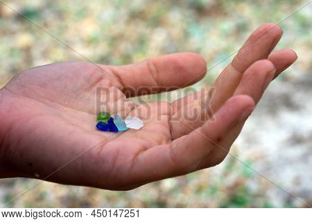 Woman Hands Holding Colored Crystals Eroded By The Sea In The Beach Of The Crystals In The Silleiro 