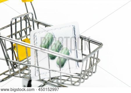 Green Chiretta Herbal Capsule In The Shopping Cart Against White Background For Healthcare And Medic