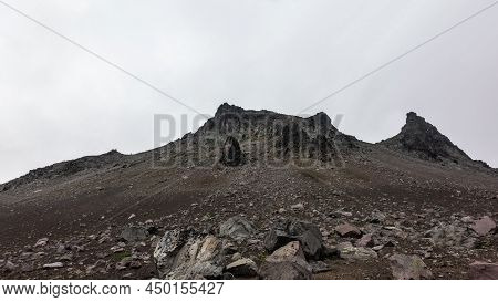 The Top Of The Mountain, Devoid Of Vegetation, Against The Background Of A Foggy Sky. Bizarre Outlin
