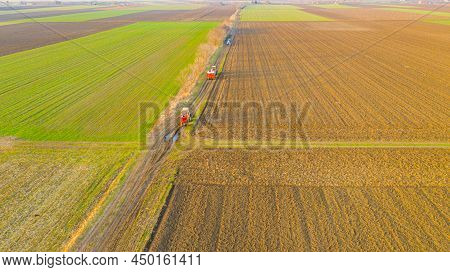 Above View Of Tractor, He Is Dragging Trailer Full Of Stuffed Sacks With Chemical Fertile, As Going 