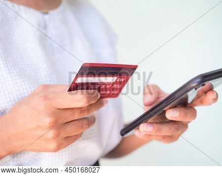Close Up Woman Holding Credit Card And Mobile Smartphone On White Background.for Shopping Online Buy