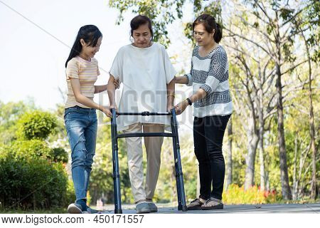 Asian Senior Woman Use Walking Aid During Rehabilitation After Physical Therapy Or Knee Surgery, Eld