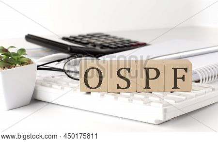 Ospf Written On Wooden Cube On Keyboard With Office Tools