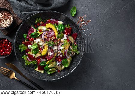 Vitamin Salad With Beetroot, Avocado, Feta Cheese And Pomegranate On A Dark Background. A Healthy, C