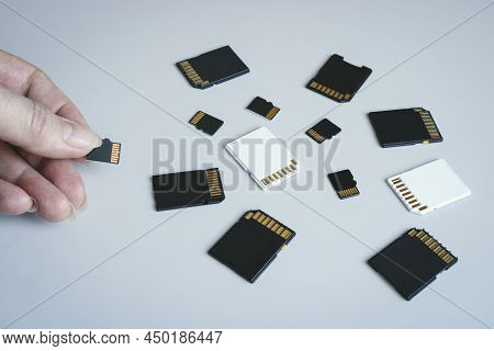 Microsd Memory Card In Hand Against The Background Of Other Sd Memory Cards.