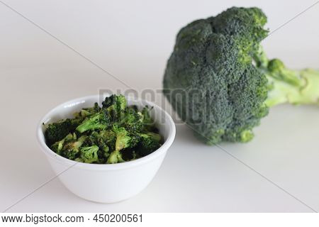 Sauteed Broccoli In A White Bowl, Shot On A White Background