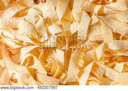 Uncooked Raw Organic Pappardelle Pasta Texture Background. Pasta From Durum Wheat Gourmet And Pasta 