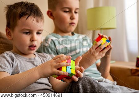 Two Male Kids Brothers Assembling Rubiks Cube Thinking Solving Logic Decision