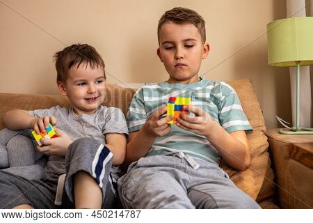 Two Male Kids Brothers Assembling Rubiks Cube Thinking Solving Logic Decision