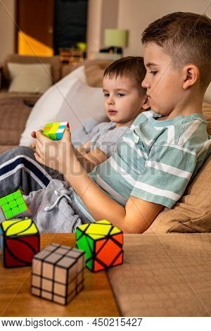 Two Male Kids Brothers Assembling Rubiks Cube Thinking Solving Logic Decision