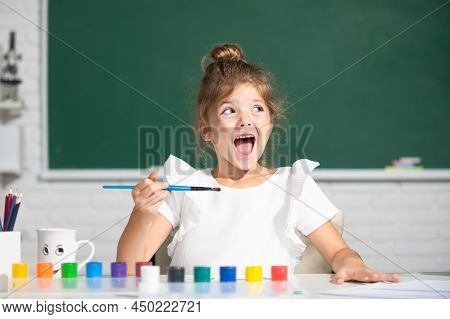 Child Girl Drawing With Coloring Pens Paintind. Portrait Of Adorable Little Girl Smiling Happily Whi