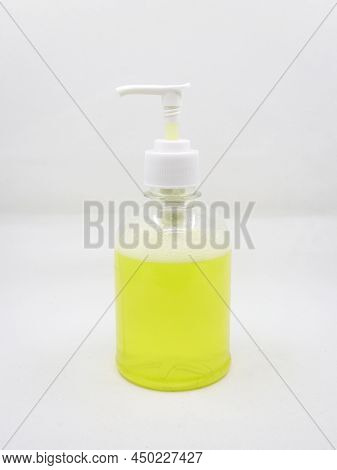 Press Type Soap Dispenser With Yellow Soap Solution For Cleaning Hands Used In Washrooms Isolated In