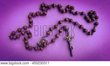 Holy Rosary On Purple Color Cover. Christianity Concept