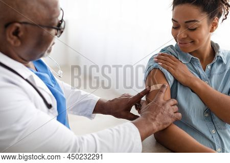 Black Woman Getting Vaccinated Against Covid, Doctor Applying Plaster