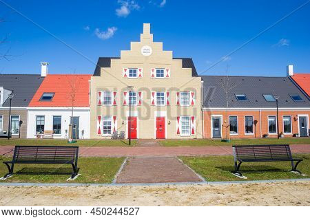 Modern House With Red Door And Shutters In Blauwestad, Netherlands
