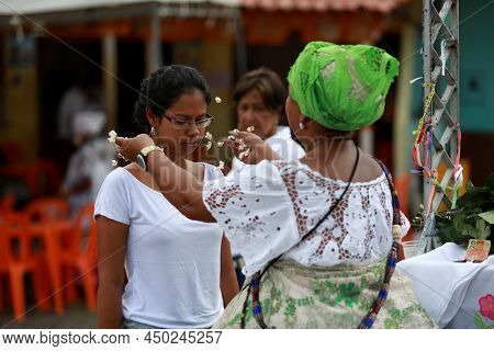 Salvador, Bahia, Brazil - January 25, 2015: Candomble Adept Receives A Spiritual Bath From A Prieste