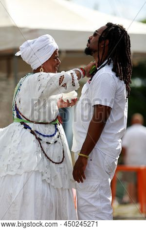 Salvador, Bahia, Brazil - January 25, 2015: Candomble Adept Receives A Spiritual Bath From A Prieste