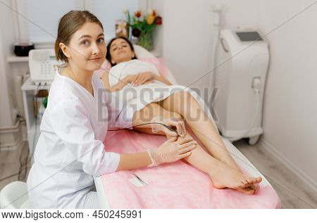 Dermatologist Doing Hair Removal Treatment On Patients Leg With Electrolysis. Depilation And Beauty 